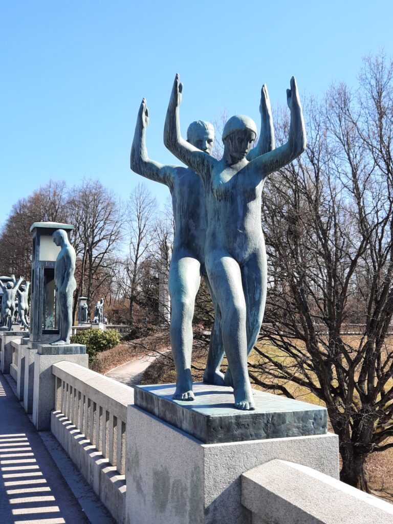 statues of people on a bridge