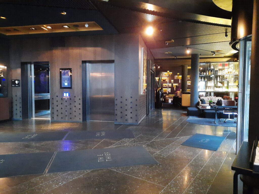 a lobby with an elevator and a bar