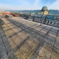 a rooftop with a view of a city and a dome